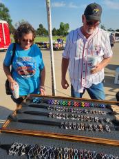 Gayla and Tom Hays of Meeker look at jewelry from a vendor