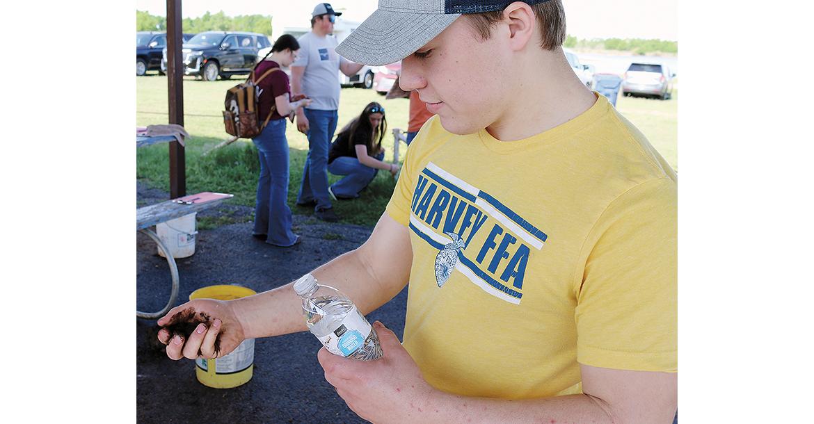Grant Anderson from Harvey, N.D. uses water to moisten a soil sample during last year’s NLRJ event_slideshow